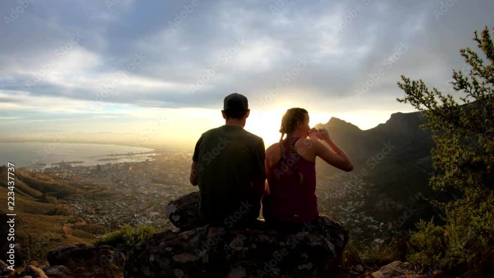 Close up, hikers overlook Cape Town at sunset