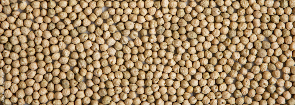 Dried chickpeas on white wooden background, top view.