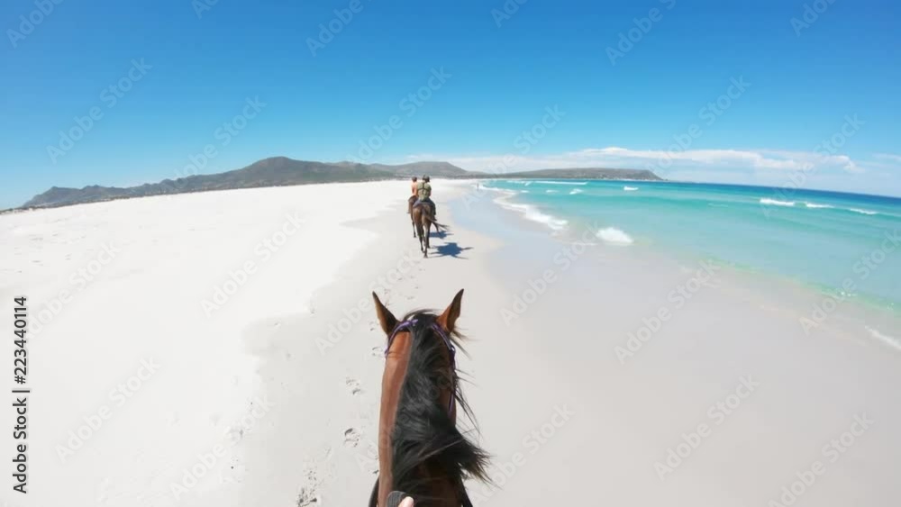 Following horse riders on beach, POV