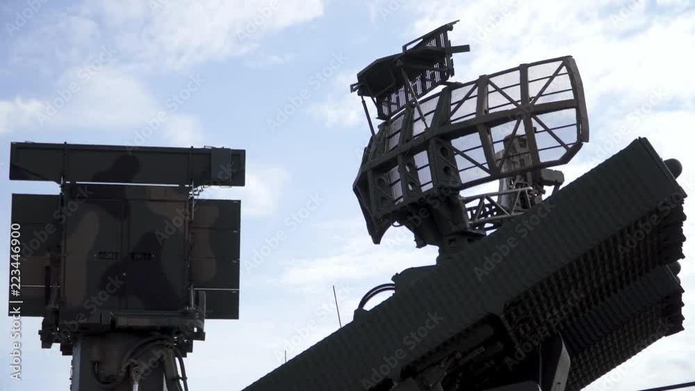 Military radar rotating next to a heavy duty antenna, on a mobile vehicle
(medium up) (slow motion)