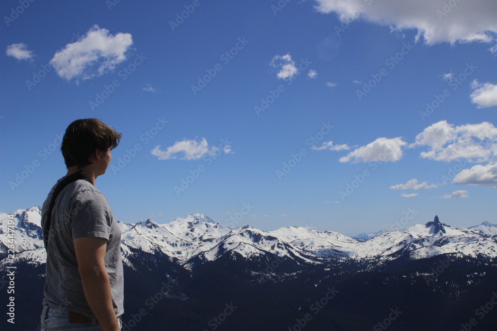 hiker with backpack is stand on mountain top, whistler british columbia Canada