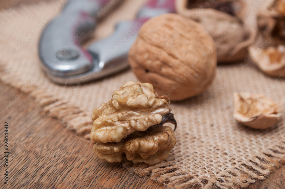 closeup of walnuts and Nutcracker on wooden background