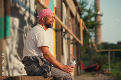 young man spray paint artist resting