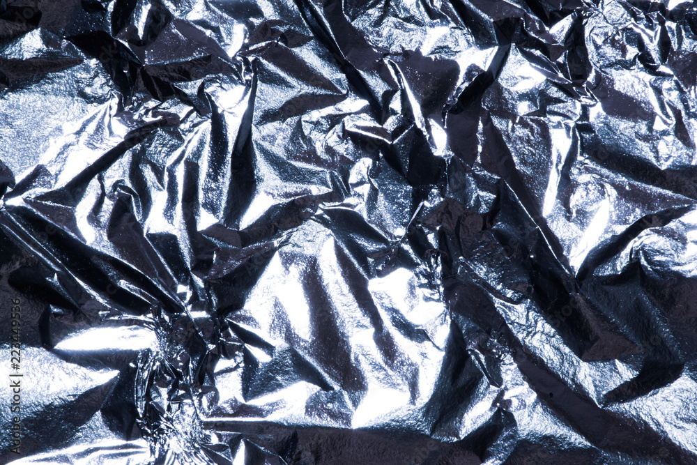 Silver bright shiny texture of a crumpled sheet. Silver bright shiny texture of a crumpled sheet.