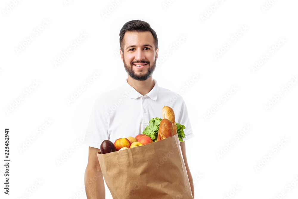 Young handsome hipster man holding a bag of food isolated on a white background. Young handsome hipster man holding a bag of food isolated on a white background.
