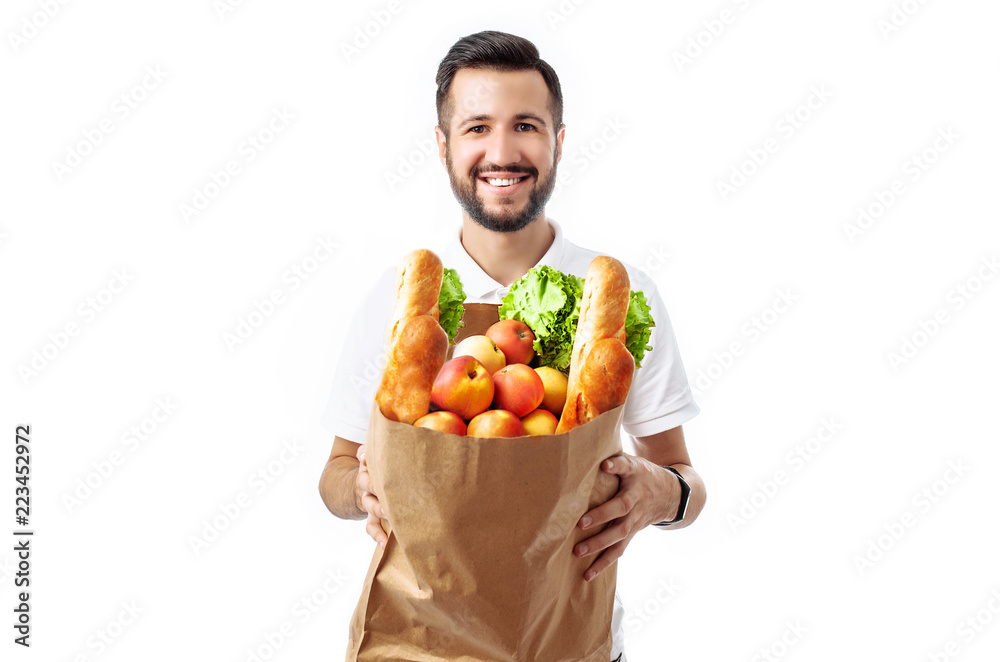 Young handsome hipster man holding a bag of food isolated on a white background. Young handsome hipster man holding a bag of food isolated on a white background.