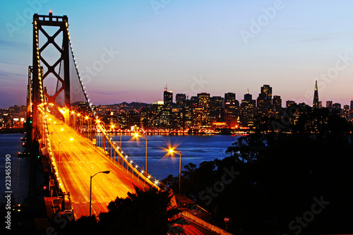 San Francisco Bay Bridge at sunset from Treasure Island - shows traffic and city lights