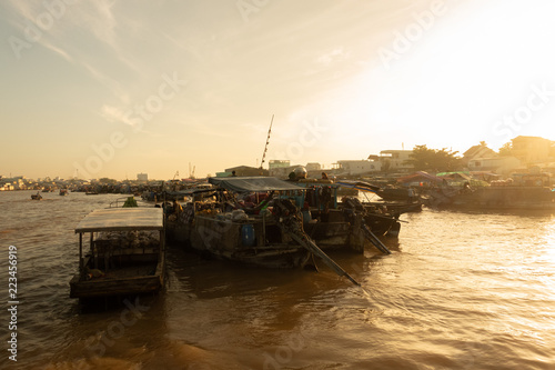 Tourists, people buy and sell food, vegetable, fruits on vessel, boat, ship in Cai Rang floating market, Mekong River. Royalty stock image of traffic on the floating market or river market in Vienam photo