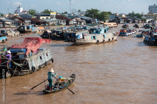 Tourists, people buy and sell food, vegetable, fruits on vessel, boat, ship in Cai Rang floating market, Mekong River. Royalty stock image of traffic on the floating market or river market in Vienam photo