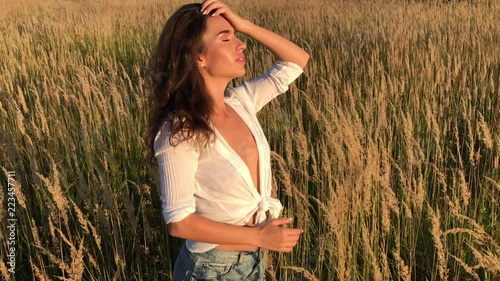 Young beautiful brunette  posing in sunset rays