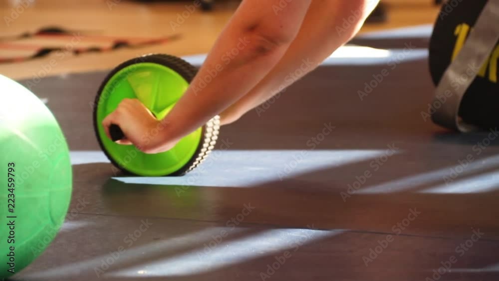 Exercise fitness roller wheel being used in a gym. Stock ビデオ Adobe Stock