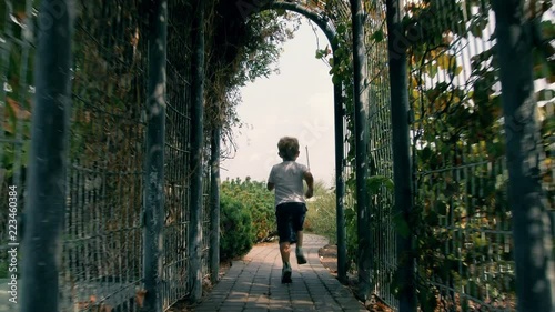 Boy running at the park in Library of the Warsaw University, summer 2018 photo