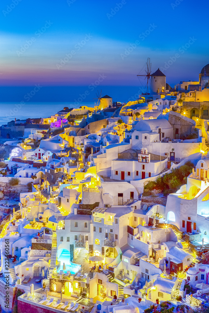 Traveling and New Destinations Concepts. Romantic Sunset at Santorini Island in Greece. Image Taken in Oia Village At Dusk. Amazing Sunset with White Houses and Windmills in Frame