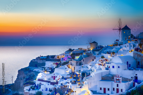 Traveling Concepts. Panoramic View of Famous Old Town of Oia or Ia at Santorini Island in Greece. Taken During Blue Hour with Traditional White Houses and Windmills.