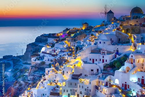 Travel Concepts. Skyline of Oia Town with Traditional White Architecture and Iconic Windmills in Village of Santorini in Greece.
