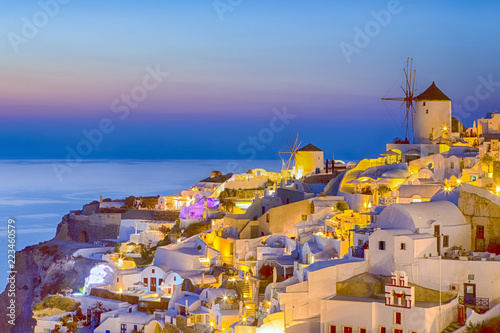 Traveling and New Destinations Concepts. Romantic Sunset at Santorini Island in Greece. Image Taken in Oia Village At Dusk. Amazing Sunset with White Houses and Windmills in Frame.