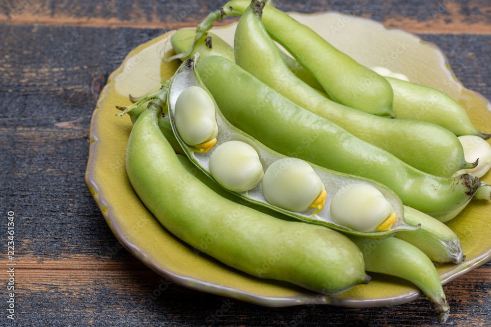 New harvest of healthy vegetables, green fresh raw big broad beans close up New harvest of healthy vegetables, green fresh raw big broad beans close up