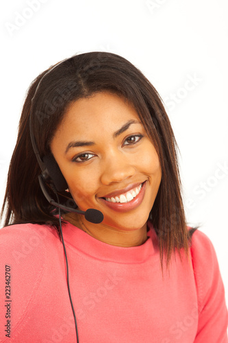 Lovely portrait of millennial female African telemarketer smiling at camera