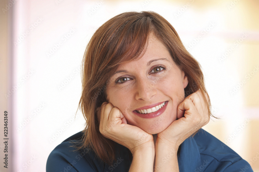 Portrait of young woman with head in hands Portrait of young woman with head in hands