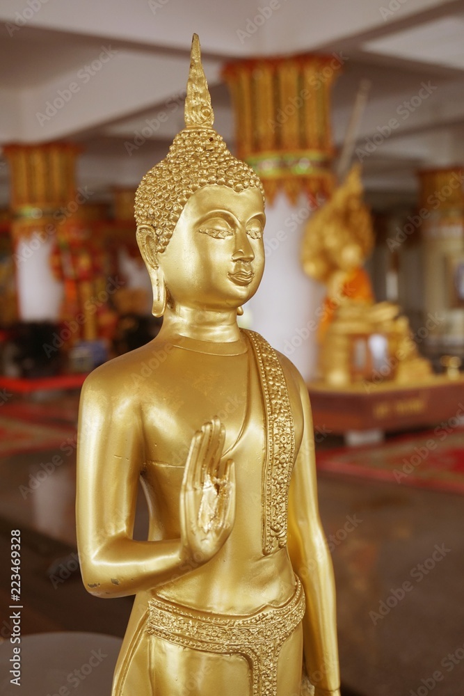 gold buddha statue in public temple Thailand
