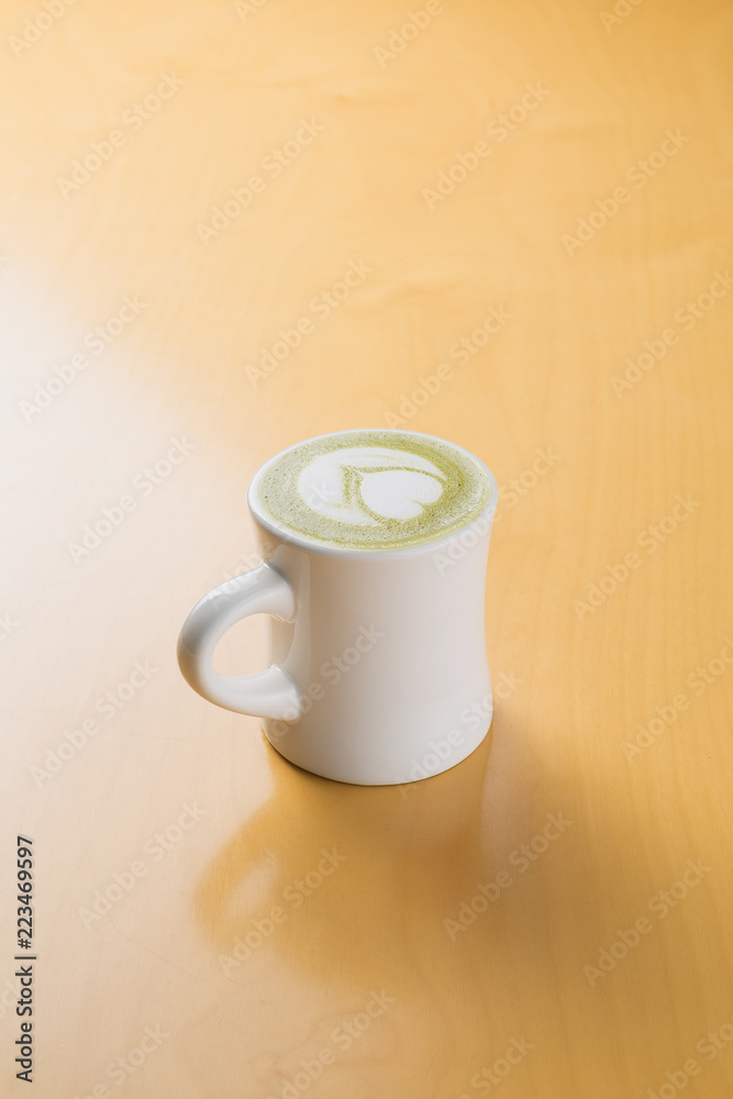 hot green tea latte on the wooden table hot green tea latte on the wooden table