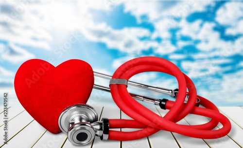 Red heart and a stethoscope on backgrouund photo