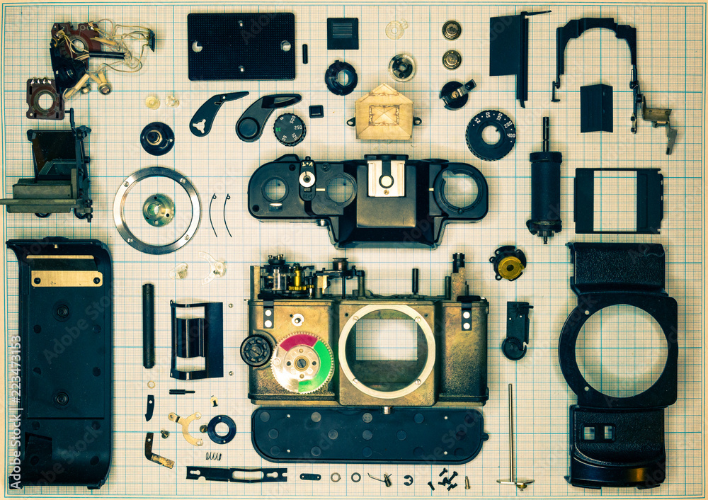 Fototapeta premium parts old retro film SLR camera on graph paper