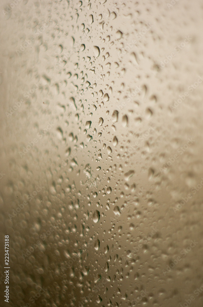 raindrops on window glass on background of cloudy sky raindrops on window glass on background of cloudy sky