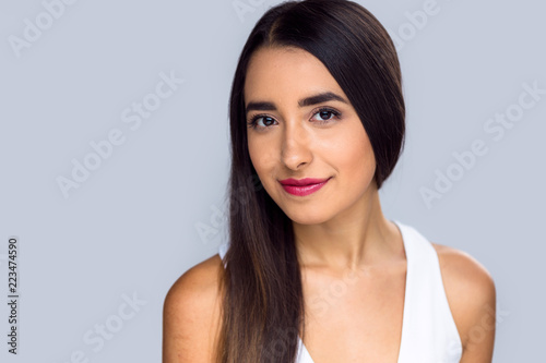 Hispanic american brunette female with radiant glowing olive tan skin