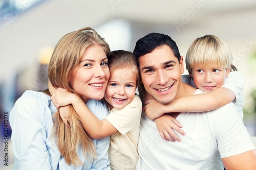 Happy family of four smiling at camera