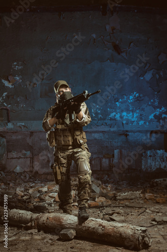 the people in uniform with weapons in the ruins