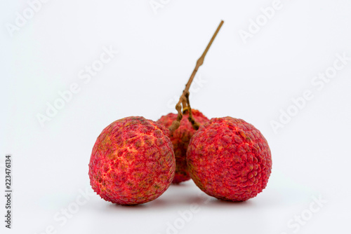 Three lychee fruit on white background