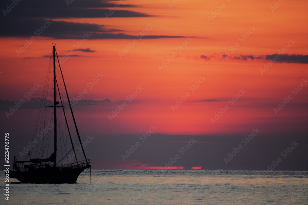 Sailboat at sunrise off the coast of Maine.