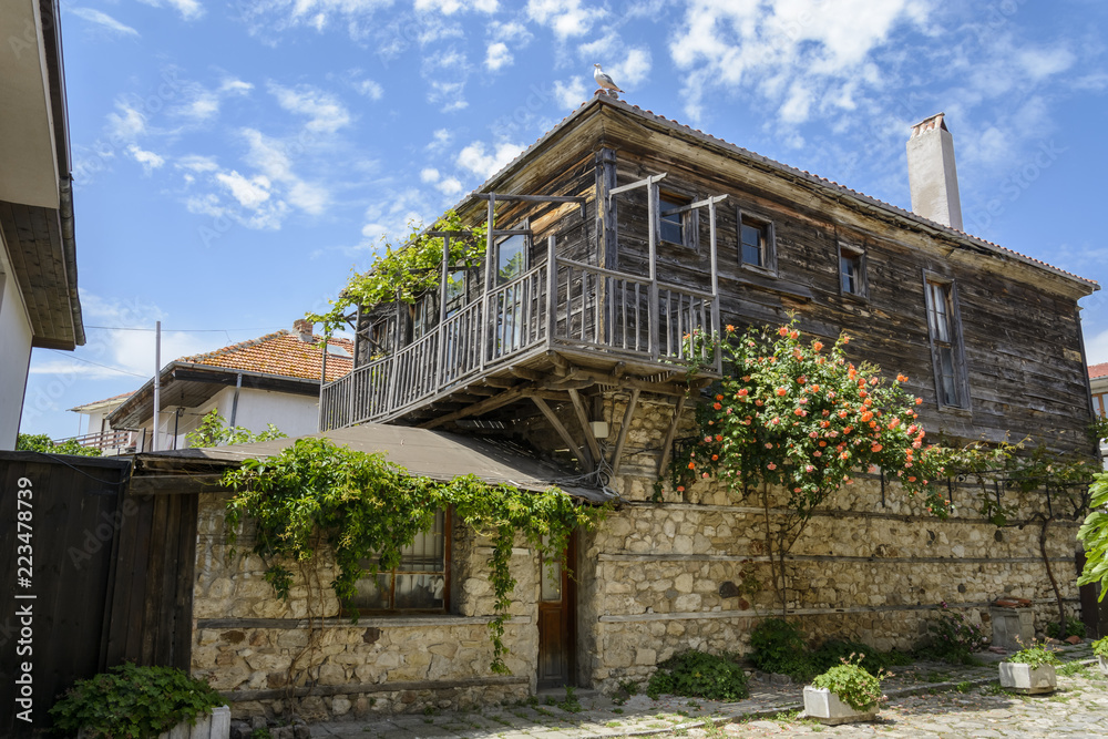traditional house in the city of nessebar, Bulgaria. flower, vibrant blue summer sky.