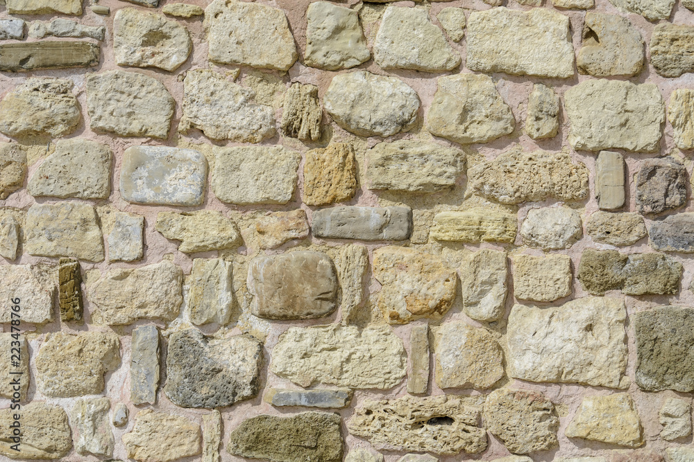 Wall with stones in random size, textured wall for background.
