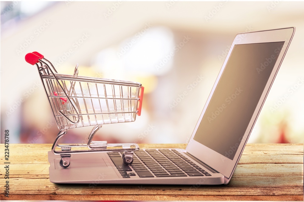 Online shopping concept with laptop and shopping