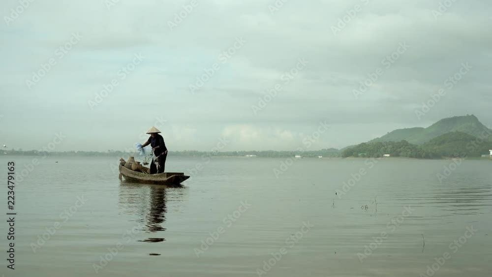 Fishermen on a rowing boat are fishing with a net. Fishermen on a rowing boat are fishing with a net.