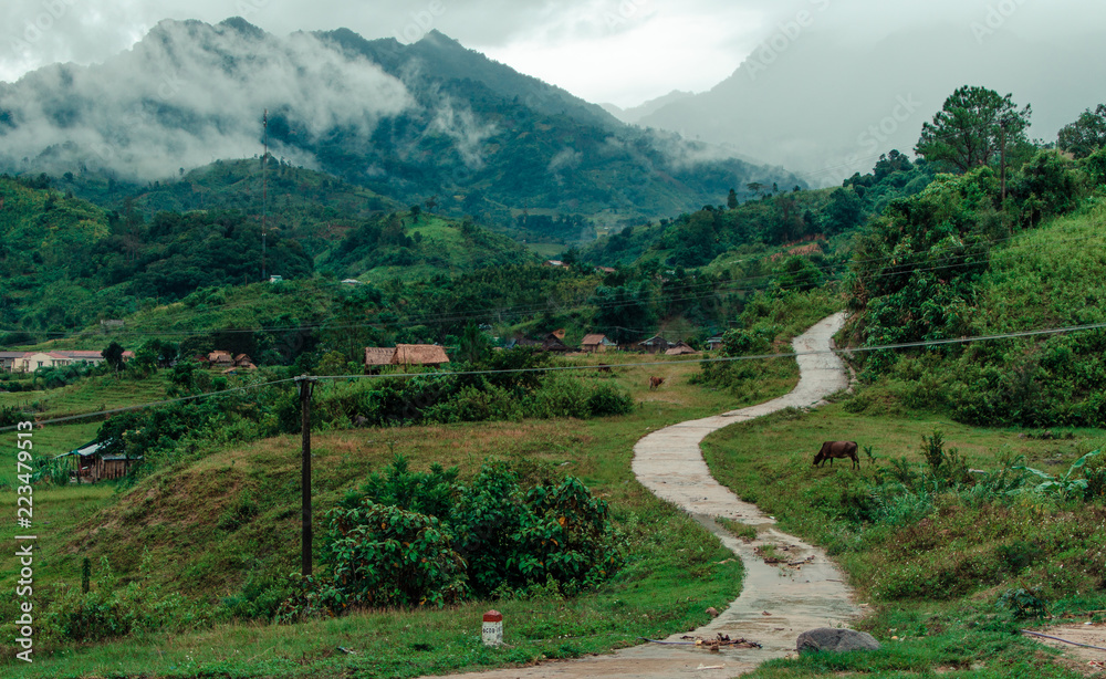 road in the mountain village in summer cloudy day road in the mountain village in summer cloudy day
