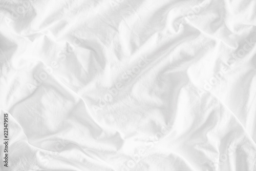 White wrinkled fabic texture rippled surface,Close up unmade bed sheet in the bedroom after night sleep Soft focus