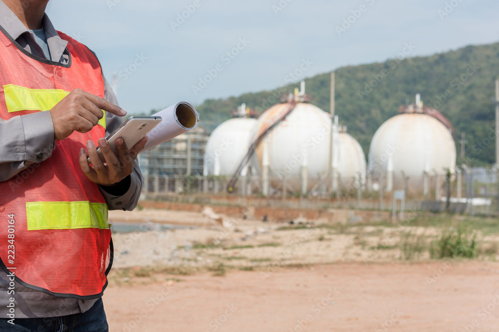 Engineer working with tablet near power plant