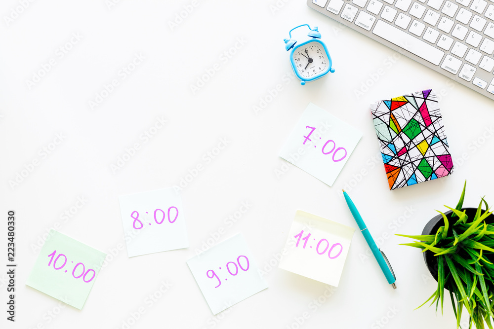 Student's schedule. Notepaper with time of lessons on white office desk with computer keyboard top view copy space Student's schedule. Notepaper with time of lessons on white office desk with computer keyboard top view copy space