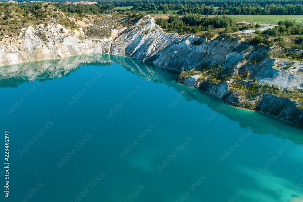 Inactive gypsum quarry. In the quarry is a lake with blue water