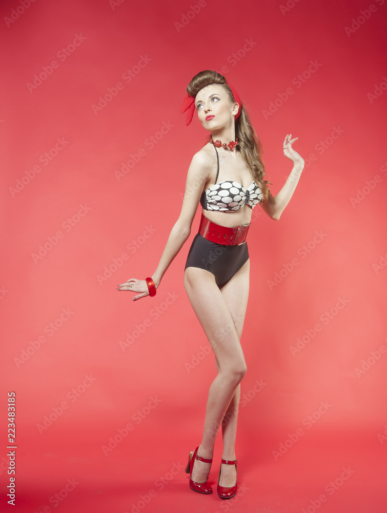 portrait of girl in pin up style on red background
