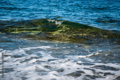 Blue sea and small wave, Crystal Clear sea over a reef in the mediterranean