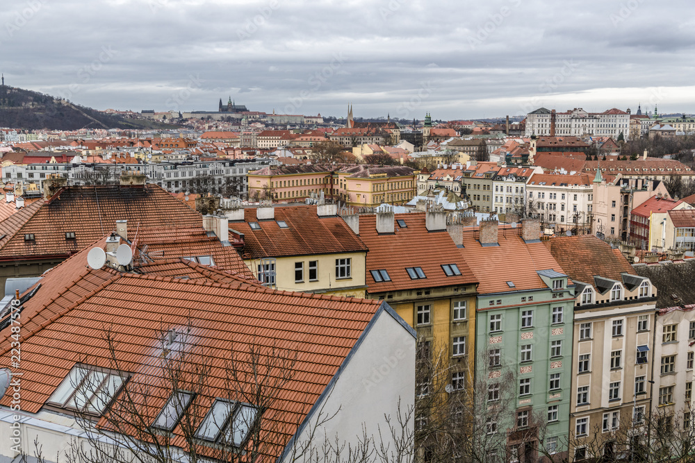 Obraz premium Storm clouds over red tile roofs