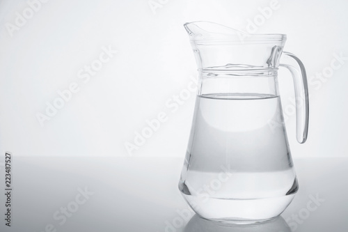Glass transparent jar filled with clean water.