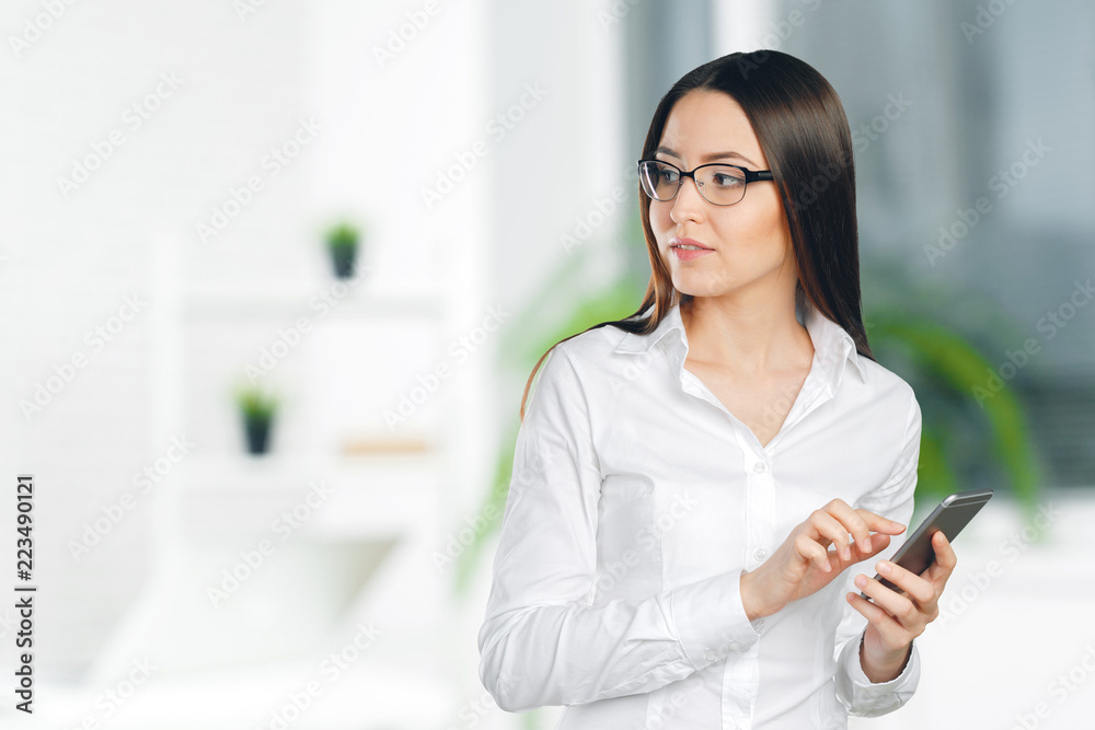 Young, confident, successful and beautiful business woman with the mobile phone isolated Young, confident, successful and beautiful business woman with the mobile phone isolated