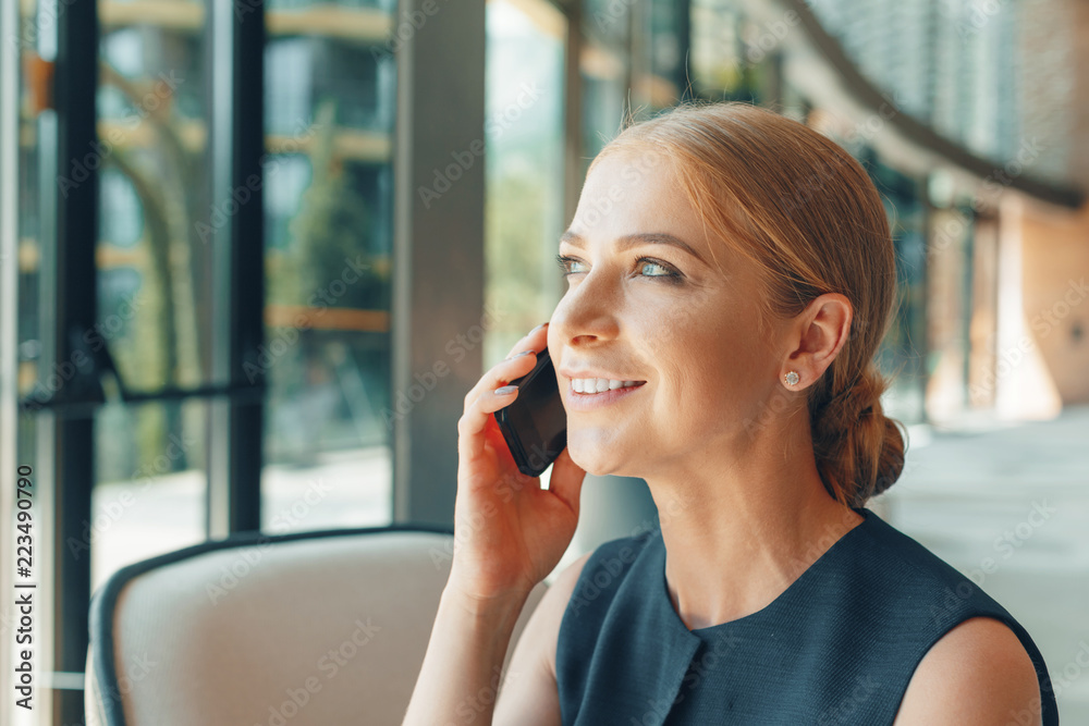 woman using mobile phone in the office woman using mobile phone in the office