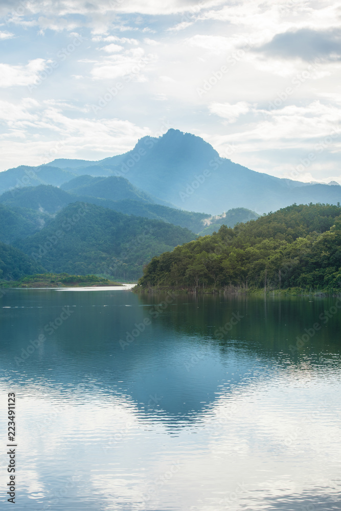 tropical mountain reflection on the lake at Phrae provine, Thailand in the cloudy day tropical mountain reflection on the lake at Phrae provine, Thailand in the cloudy day
