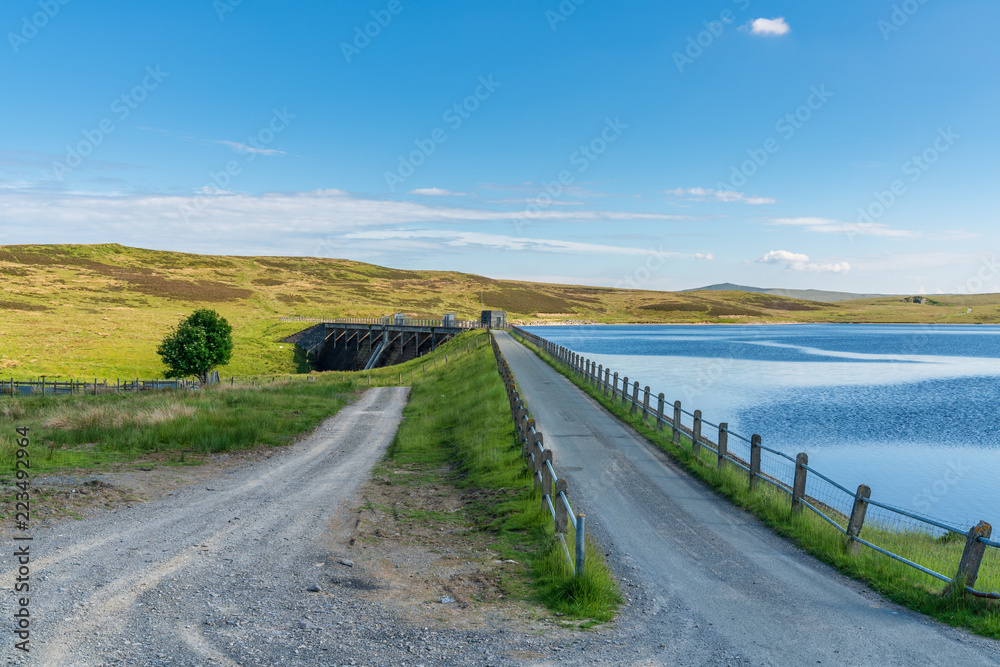 Rural road in Wales, leading to the dam at the Aled Isaf Reservoir, Conwy, Wales, UK
